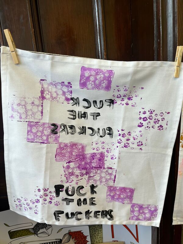 Printed serviette with letters reading 'FUCK THE FUCKERS'
